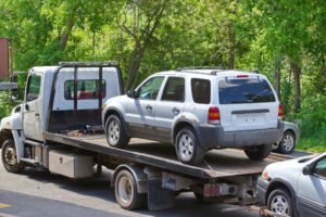 flatbed tow truck loading an SUV before transport to a Santa Cruz County impound lot
