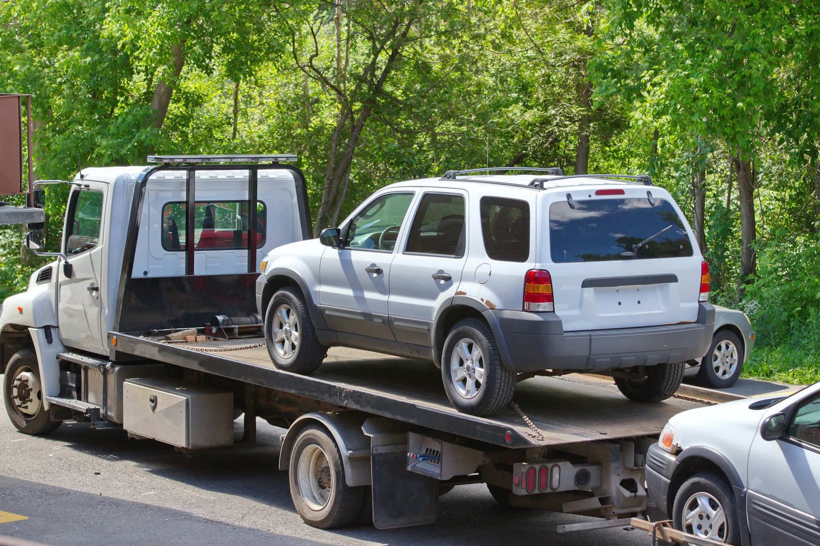 flatbed tow truck loading an SUV before transport to a Santa Cruz County impound lot