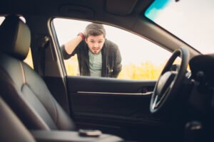 driver looking through the window at keys left on the seat of a locked car in Santa Cruz