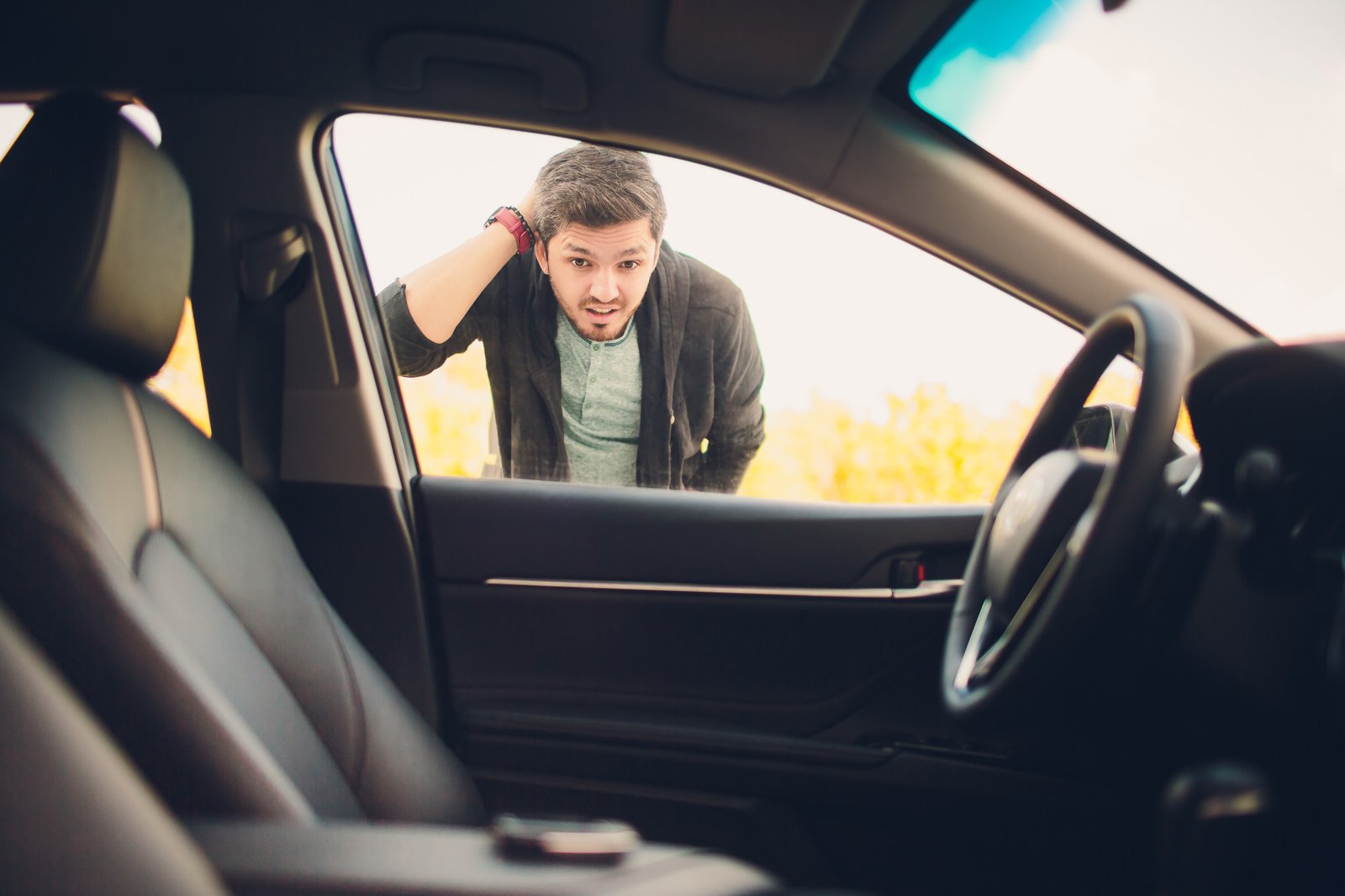 driver looking through the window at keys left on the seat of a locked car in Santa Cruz