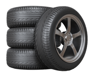 stack of four car tires with alloy wheels for flat tire service near Santa Cruz CA
